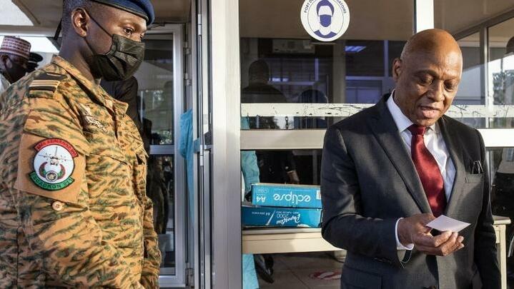 President of the Economic Community of West African States (ECOWAS), Jean-Claude Kassi Brou (R) makes his way to the airport after addressing the press in Ouagadougou on January 31, 2022. – Burkina Faso&rsquo;s military junta said on January 31, 2022, it had restored the constitution a week after taking power and appointed the coup&rsquo;s leader as head of state for a transitional period. On January 24, 2022 a coup was declared in Burkina Faso with new strong man and head of the Junta, Lieutenant-Colonel Paul-Henri Sandaogo Damiba ousting former President, Roch Marc Christian Kabore. Ecowas went on to suspend them in the aftermath of the coup. (Photo by JOHN WESSELS / AFP)