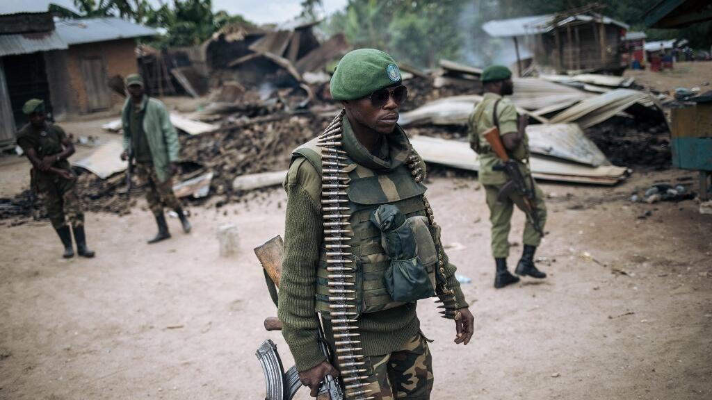 An Armed Forces of the Democratic Republic of Congo (FARDC) soldier takes part in a foot patrol in the village of Manzalaho near Beni on February 18, 2020, following an attack allegedly perpetrated by members of the rebel group Allied Democratic Forces (ADF). (Photo by Alexis Huguet / AFP)