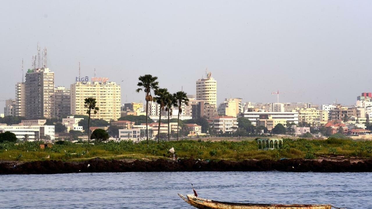 A pirogue boat is anchored off the shores of the Senegalese capital Dakar on October 3 , 2017. (Photo by SEYLLOU / AFP)