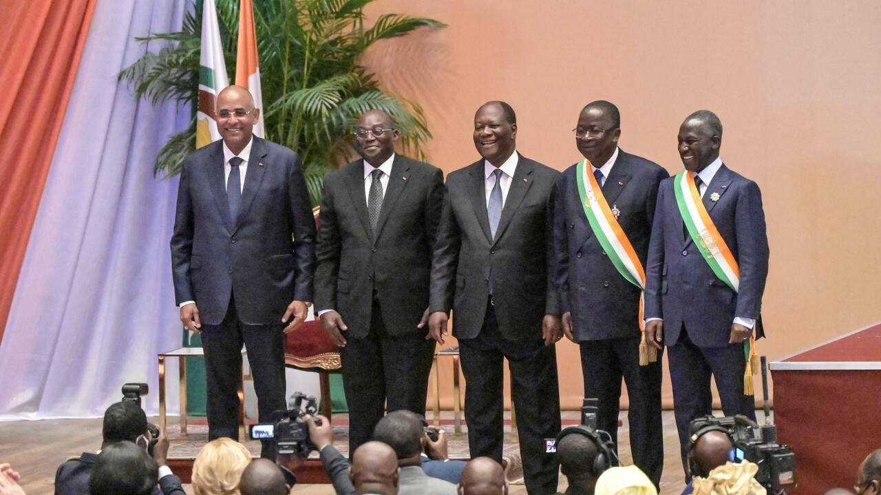 Ivorian President Alassane Ouattara (C), the new Ivorian vice president Tiemoko Meyliet Kone (2nd L), Ivorian Prime Minister Patrick Achi (L), the president of the senate, Jeannot Ahoussou Kouadio (2nd R), and the president of the National Assembly Adama Bictogo (R) pose for a photo in front of senators and parliamentarians at the Felix Houphouet Boigny Foundation for Research in Yamoussoukro on April 19, 2022. (Photo by Sia KAMBOU / AFP)